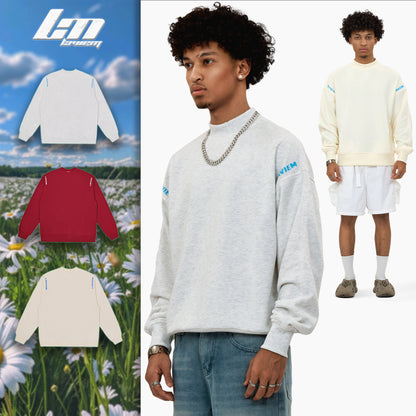 Flat lay of the LAVIEM Oversized Sweater in multi color, arranged on a neutral background with folded sleeves to showcase its soft cotton fabric, streetwear-inspired boxy cut, and ribbed collar. Styled with minimalist accessories for a casual urban aesthetic.